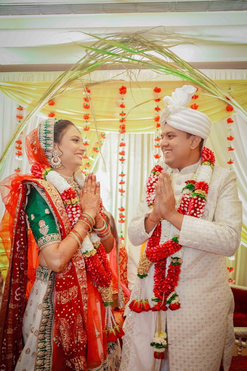 Couple during a ceremony under floral decor