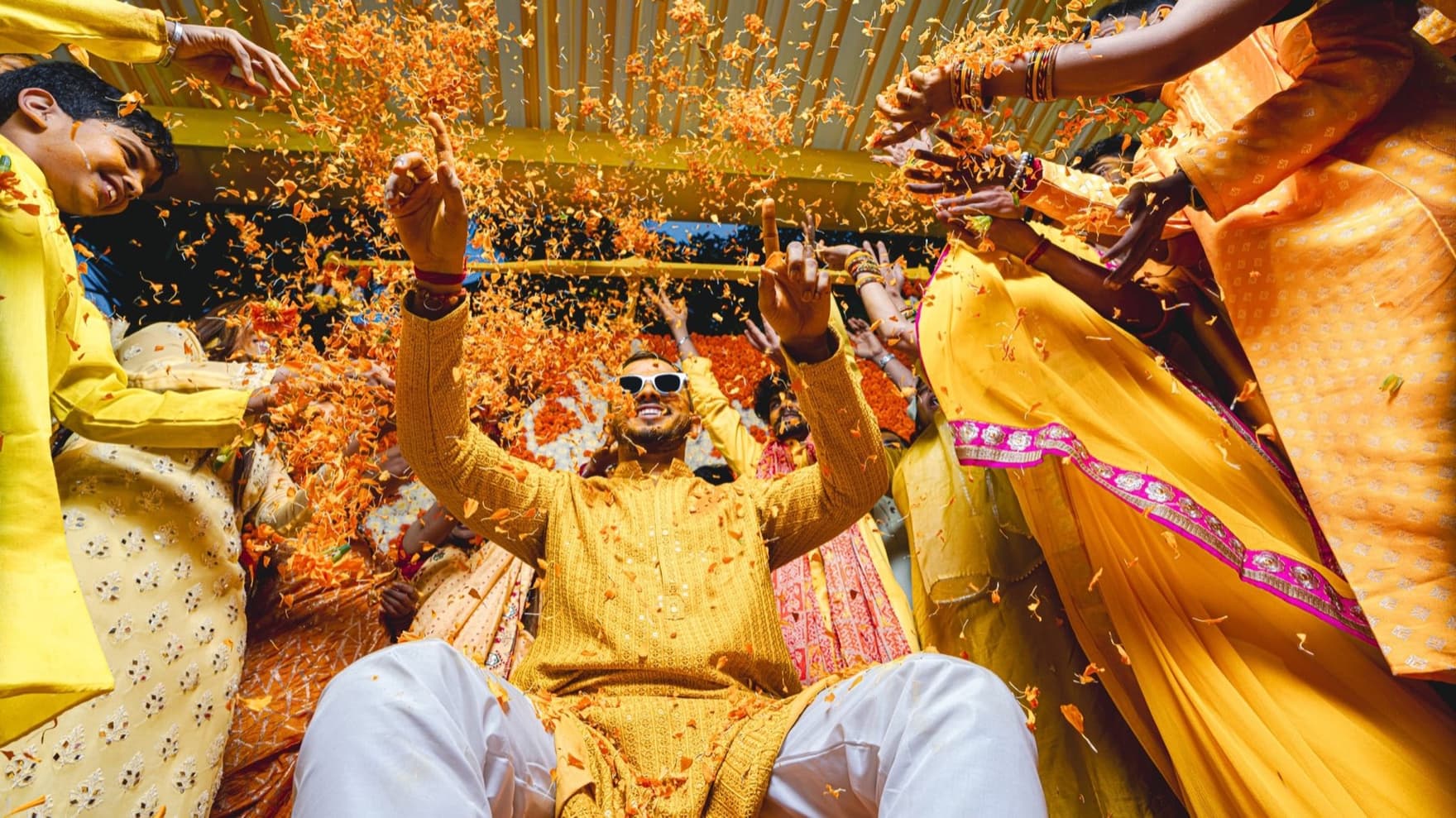 Haldi ceremony, family showering turmeric